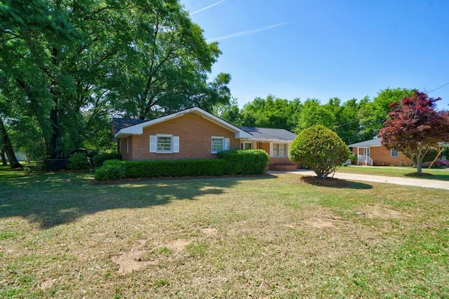 single story home featuring a front lawn and brick siding