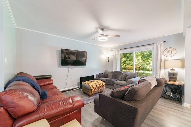 living area with baseboards, light wood-style floors, and ceiling fan