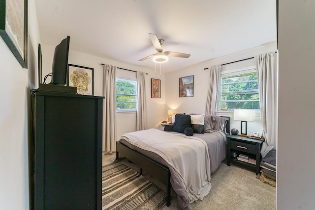 bedroom featuring a ceiling fan and light carpet
