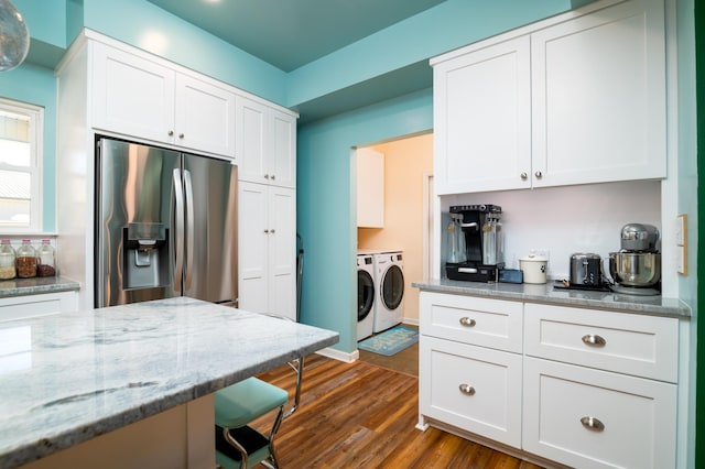 212 Chester Ln, Cottageville, SC 29435 - kitchen featuring stainless steel fridge with ice dispenser, light stone countertops, washing machine and clothes dryer, dark wood finished floors, and white cabinets