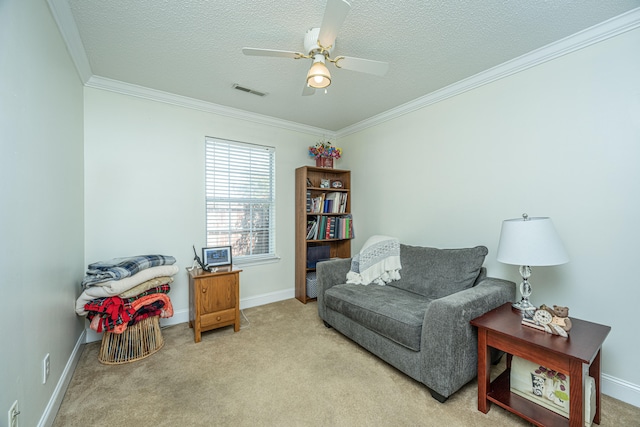 living area with light carpet, a textured ceiling, crown molding, and ceiling fan