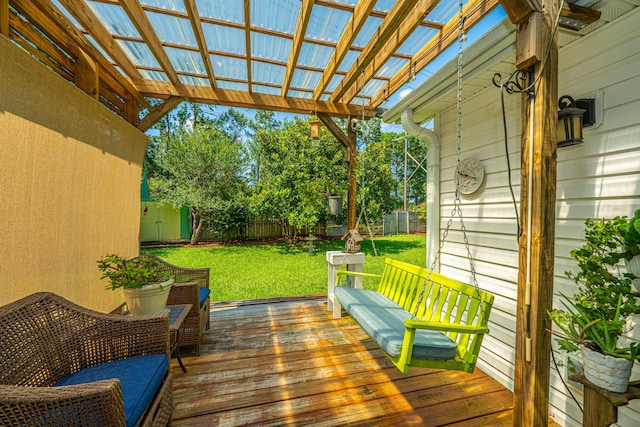 deck with a pergola and a lawn