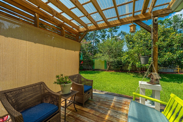 wooden terrace featuring a pergola, a lawn, and a shed