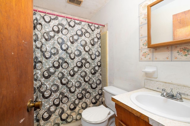 bathroom featuring vanity, toilet, a textured ceiling, and a shower with shower curtain