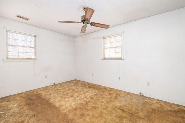 spare room with carpet floors and ceiling fan