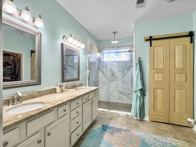 bathroom with vanity and a tile shower