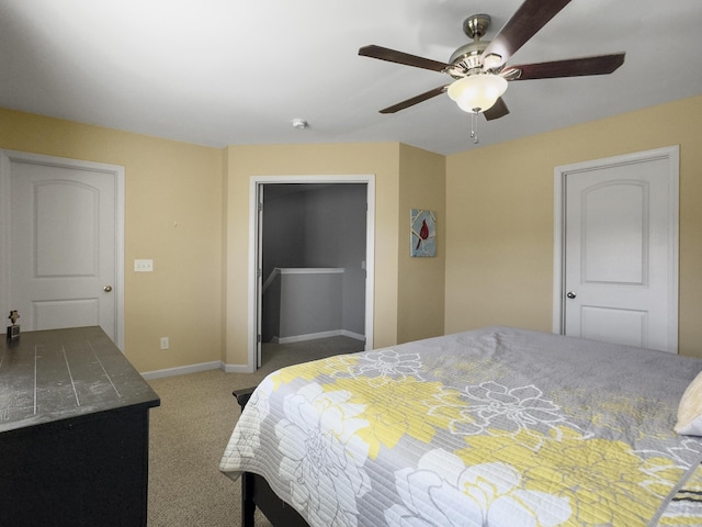 carpeted bedroom with ceiling fan and a closet