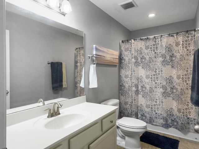 bathroom featuring vanity, toilet, and curtained shower