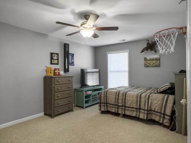 bedroom with ceiling fan and light carpet