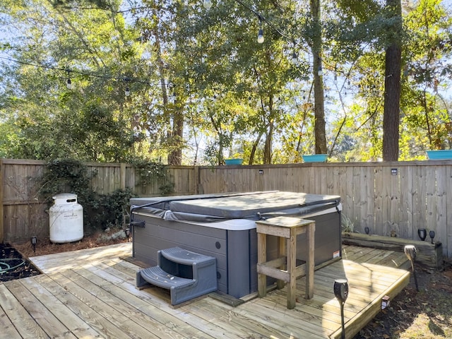 wooden deck featuring a hot tub