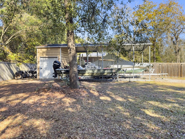 view of yard with a garage and an outdoor structure