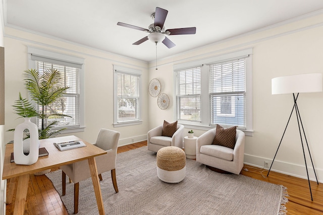 office with wood finished floors, ornamental molding, baseboards, and ceiling fan