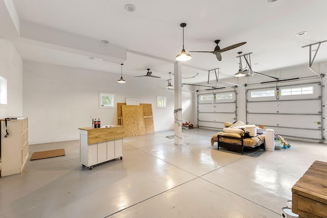 garage with a garage door opener and a ceiling fan