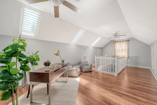additional living space with baseboards, ceiling fan, vaulted ceiling, and wood finished floors
