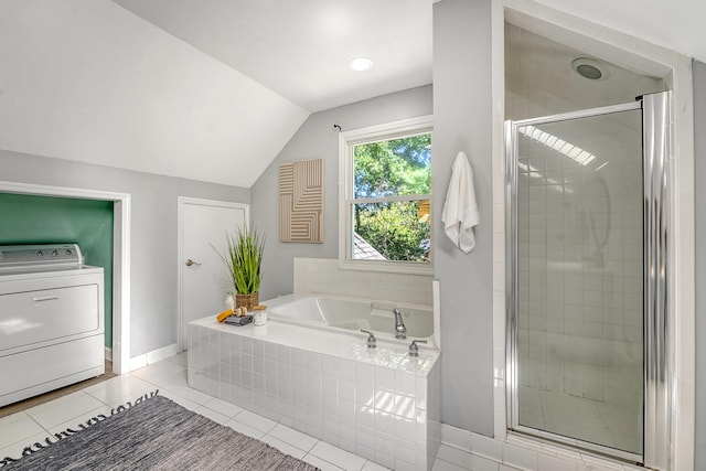 bathroom featuring tile patterned floors, washer / clothes dryer, a shower stall, vaulted ceiling, and a bath