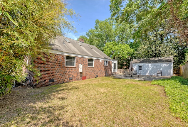view of yard with fence, an outdoor structure, and a patio area
