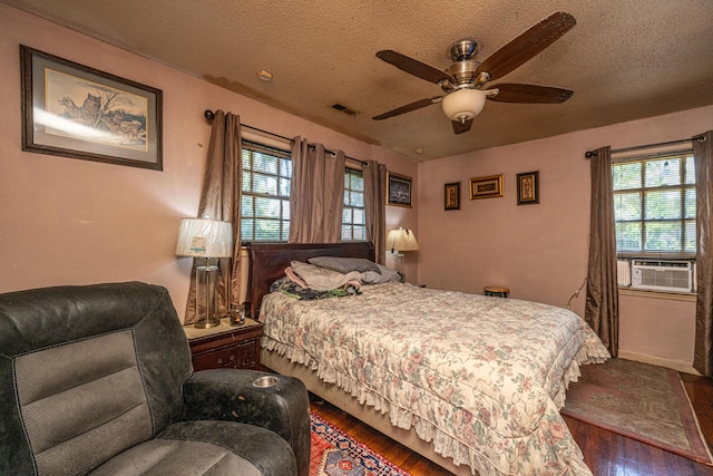 5302 Helene Dr, North Charleston, SC 29418 - bedroom featuring cooling unit, hardwood / wood-style flooring, multiple windows, a textured ceiling, and ceiling fan
