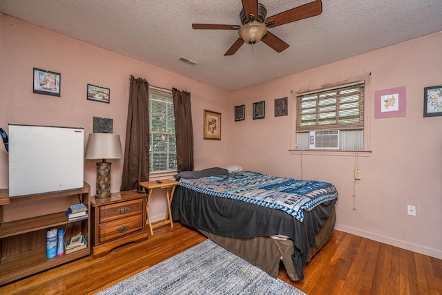 5302 Helene Dr, North Charleston, SC 29418 - bedroom with wood finished floors, multiple windows, a textured ceiling, ceiling fan, and cooling unit