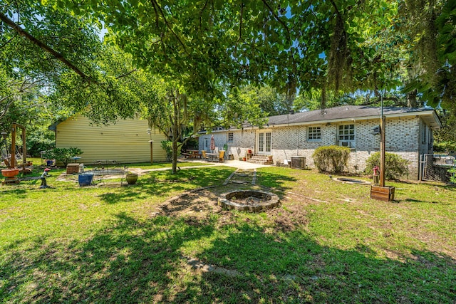 5302 Helene Dr, North Charleston, SC 29418 - view of grassy yard featuring a fire pit, a patio, and entry steps