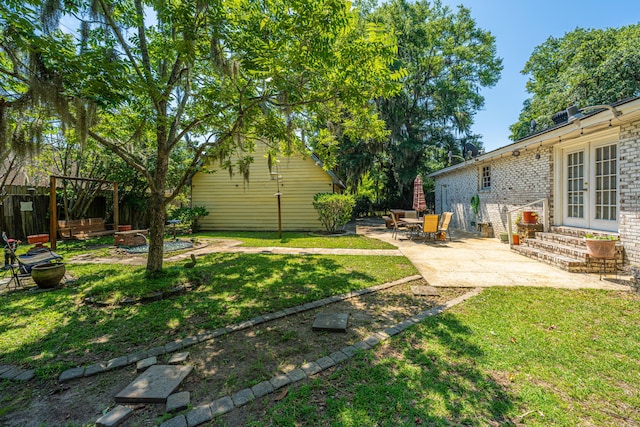 5302 Helene Dr, North Charleston, SC 29418 - view of grassy yard with a patio area, french doors, and entry steps