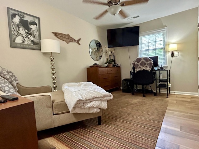 living room featuring ceiling fan and hardwood / wood-style flooring