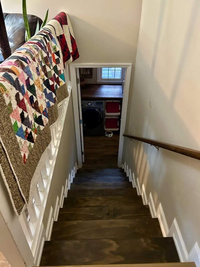 stairway with wood-type flooring and washer / clothes dryer