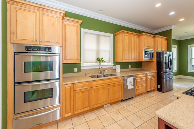 kitchen with light tile patterned floors, appliances with stainless steel finishes, ornamental molding, a sink, and a warming drawer