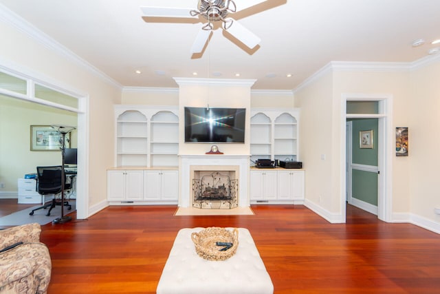 living room with ornamental molding, dark wood-type flooring, and ceiling fan