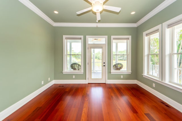 interior space featuring crown molding, dark wood finished floors, visible vents, and baseboards