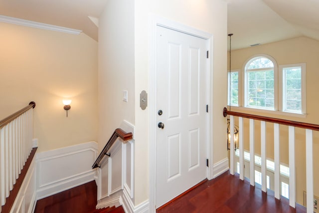 entrance foyer with lofted ceiling and dark hardwood / wood-style floors