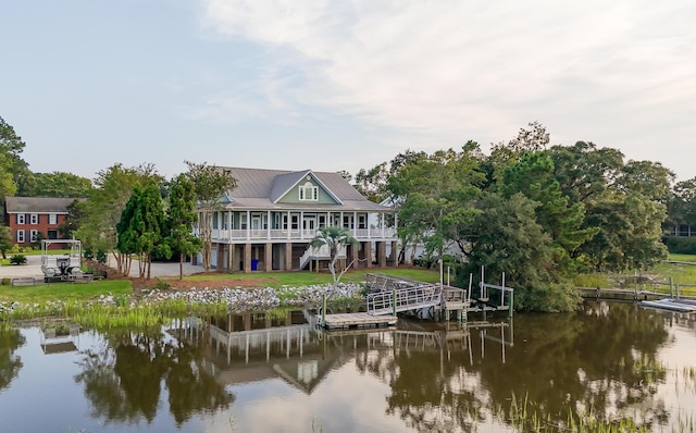 back of house featuring a water view and stairway