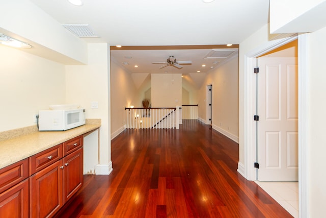 hall featuring dark wood finished floors, an upstairs landing, visible vents, and recessed lighting