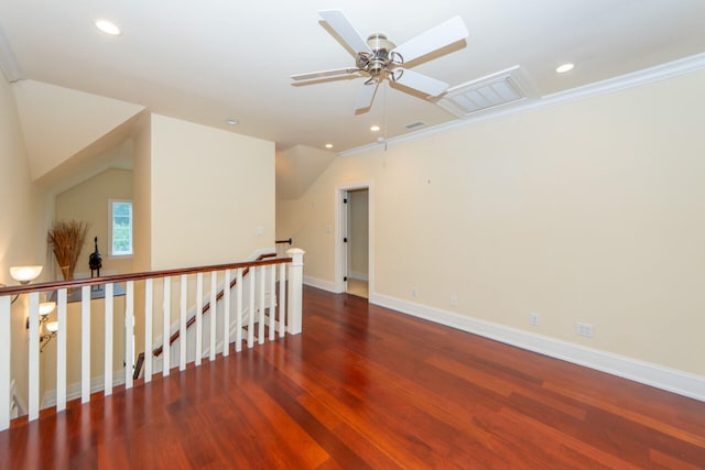 spare room with dark wood-type flooring, recessed lighting, vaulted ceiling, and baseboards