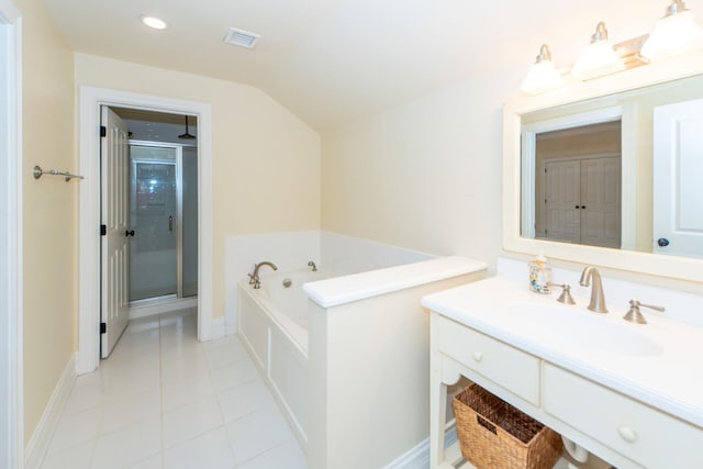 full bathroom featuring a garden tub, vanity, vaulted ceiling, tile patterned floors, and a stall shower