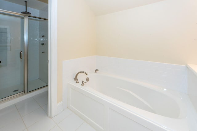 bathroom featuring a garden tub, a shower stall, and tile patterned floors