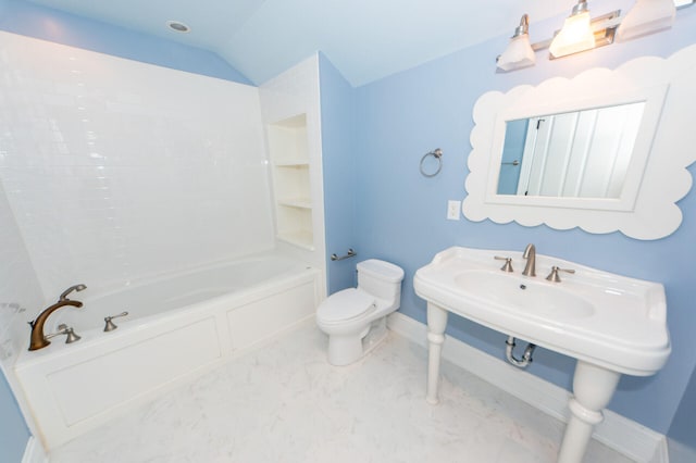 bathroom with marble finish floor, lofted ceiling, toilet, washtub / shower combination, and baseboards