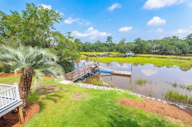 dock area with a water view and a lawn