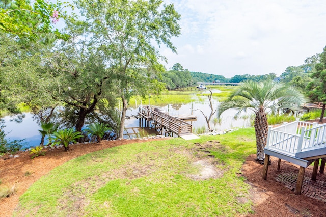 dock area featuring a lawn and a water view