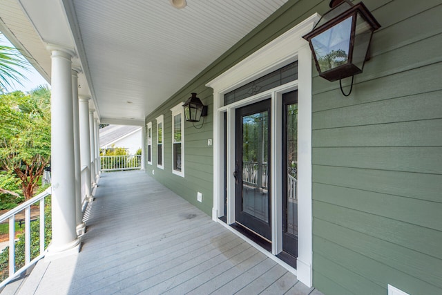 wooden terrace featuring covered porch