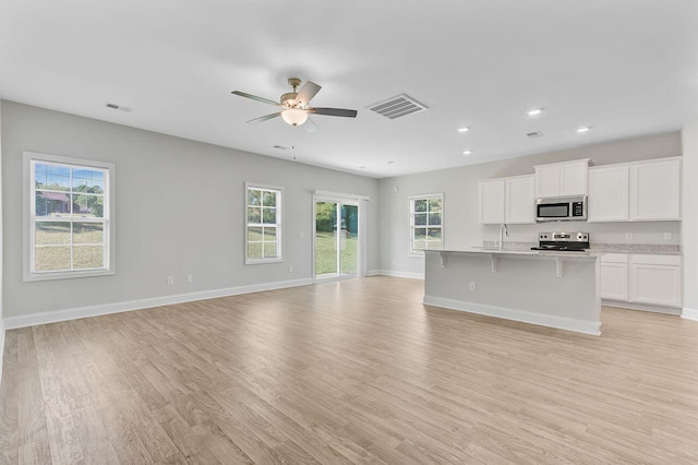 224 Young Town Cir, Orangeburg, SC 29118 - unfurnished living room featuring light wood-type flooring, visible vents, and ceiling fan