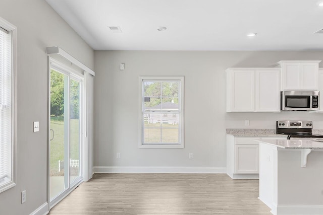 224 Young Town Cir, Orangeburg, SC 29118 - kitchen featuring light stone counters, white cabinets, appliances with stainless steel finishes, and light wood-style floors