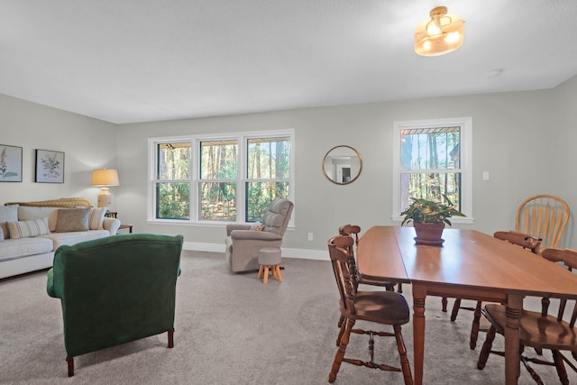 dining space with baseboards and carpet floors