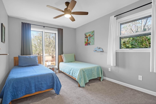 bedroom featuring multiple windows, a ceiling fan, carpet, and baseboards