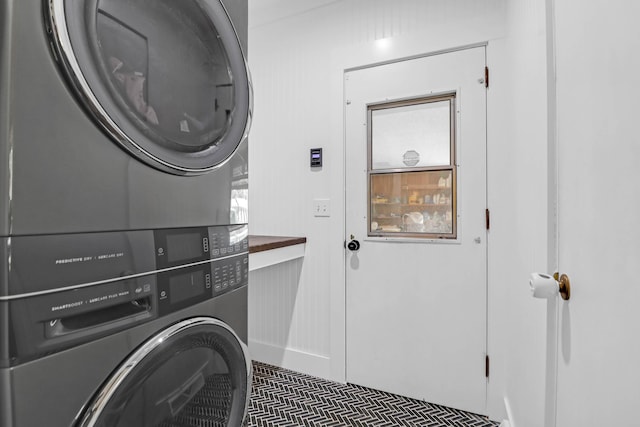 laundry area featuring laundry area and stacked washer / drying machine