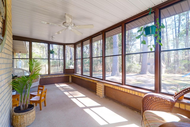 sunroom featuring ceiling fan