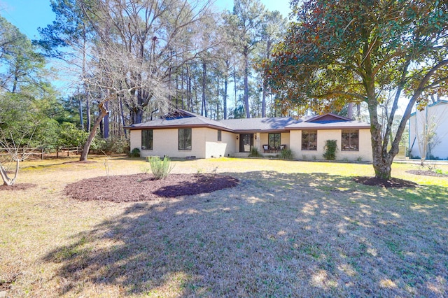 single story home featuring brick siding and a front lawn