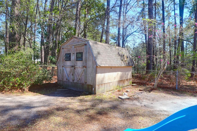 view of shed featuring fence