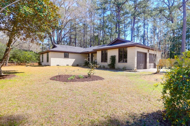 view of front of house featuring crawl space, an attached garage, a front yard, and brick siding