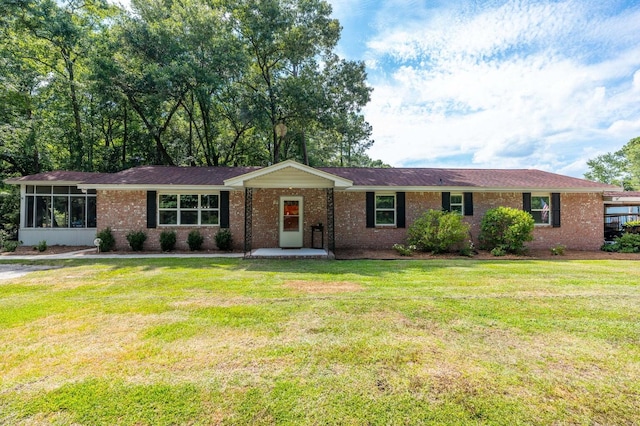 ranch-style home featuring a front yard