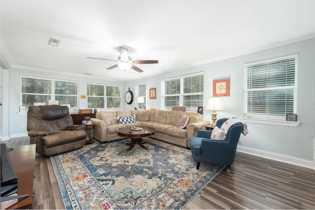 living room with ornamental molding, dark wood-type flooring, and ceiling fan